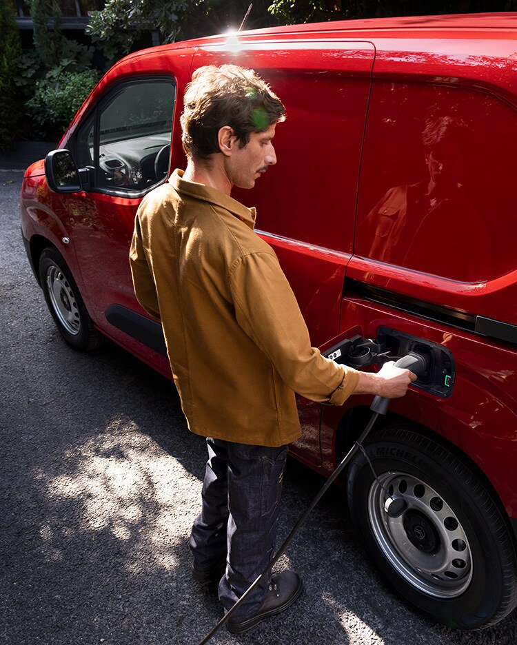 Man charging his red new ë-Berlingo Van